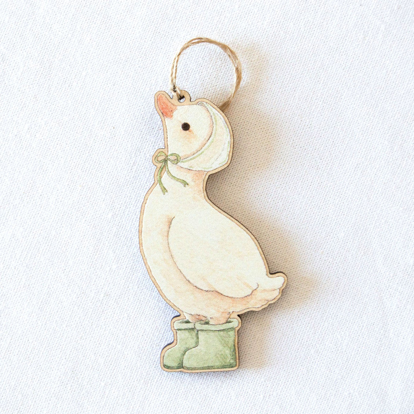 Rainy Duck wooden hanging decoration by Beccotti on cloth.